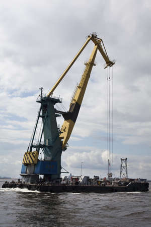 St. Petersburg, Russia – July 17: Transportation floating crane in the Finnish Gulf in...
