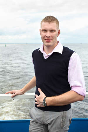 One handsome Caucasian man standing on deck of yachtの写真素材