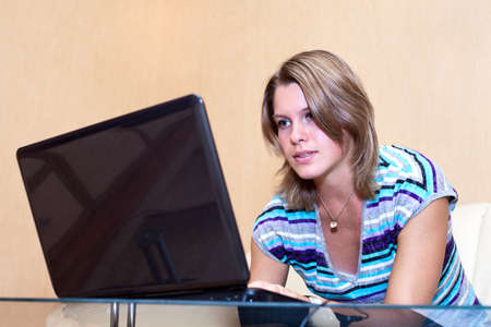Young woman playing in games on laptopの写真素材