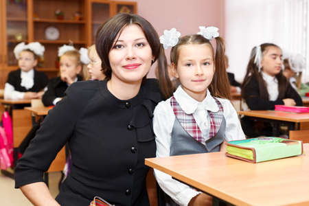 SAINT-PETERSBURG, RUSSIA - September 1: Mother and school-girl in school classroom sitting at a deskのeditorial素材