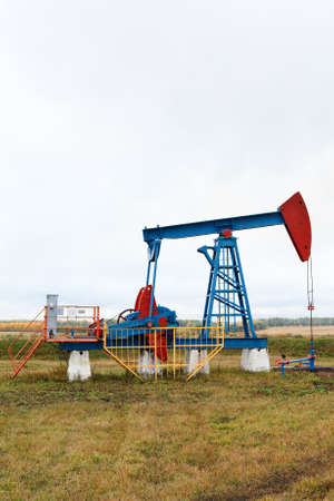 One pump jacks on a oil field. Autumnの写真素材