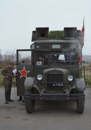 SAINT-PETERSBURG, RUSSIA  NOVEMBER 4: Military performance in celebration of National Unity Day. Soviet bus with red flags on November 4, 2011 in Saint-Petersburg, Russia.のeditorial素材