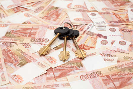 House keys on money cashnotes backgroundの写真素材