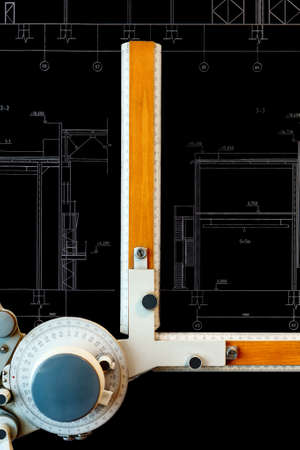 Old-fashioned drawing board with black project blueprint