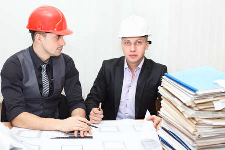 Architect and construction engineer discussing plan in office roomの写真素材
