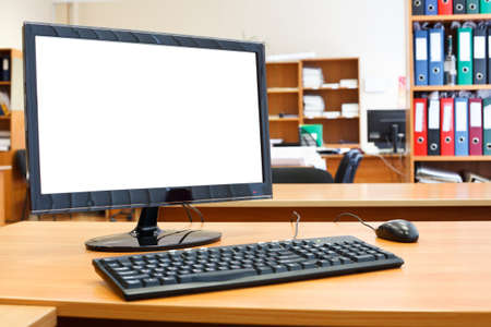 Modern personal computer on desktop in office roomの写真素材