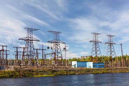 Electric power transmission on hydroelectric station on blue skyの写真素材