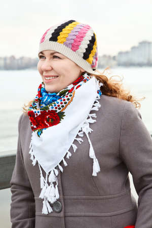 Close up portrait of happy young Caucasian female with scarf on neck  Standing outdoorの写真素材