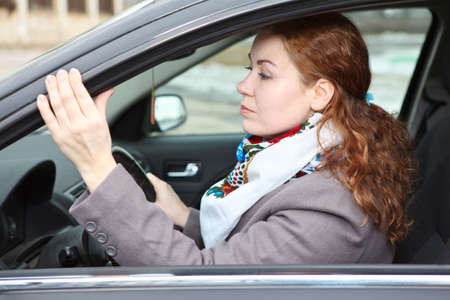 Pretty young Caucasian woman driving a carの写真素材