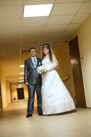 Young wedding Caucasian Russian couple standing in long corridorの写真素材