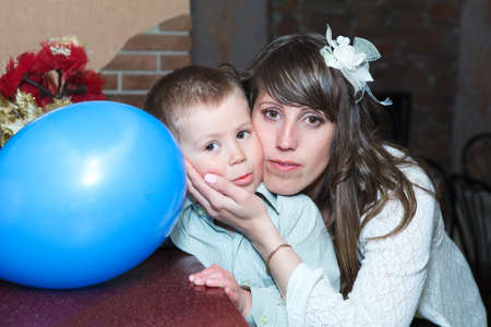 Young mother and small child embracing togehtherの写真素材