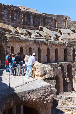 TUNISIA - CIRCA MAY, 2012: People the tourists looking from review area at demolished ancient walls and arches in Amphitheater in El Djem, on circa May, 2012 in Tunisia.のeditorial素材