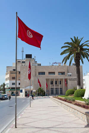 SOUSSE, TUNISIA - CIRCA MAY, 2012: An Central bank of Tunisia building in Sousse city, Tunisia. National flags on the streetのeditorial素材