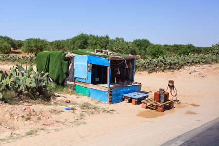 SOUSSE, TUNISIA - CIRCA MAY, 2012: Booth for the illegal trade in gasoline on the highway from Tunisia to Libya, on circa May, 2012 in Sousse, Tunisia.のeditorial素材