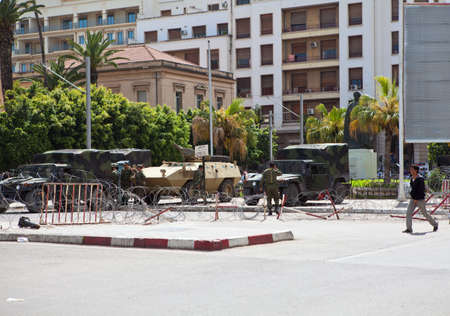 TUNIS CITY, TUNISIA - CIRCA MAY, 2012: Military guards with guns in war car before administration...
