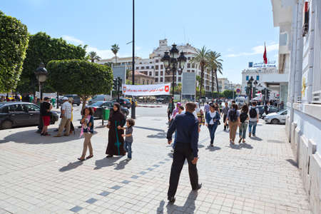 TUNIS, TUNISIA - CIRCA MAY, 2012: Tunisian people walking on the pavement. Habib Bourguiba avenue, on circa May, 2012 in Tunis, Tunisia.のeditorial素材