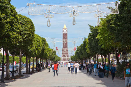 TUNIS, TUNISIA - CIRCA MAY, 2012: The central alley with people and Tower of Big Ben clock in the center of capital, on circa May, 2012 in Tunis, Tunisia.のeditorial素材