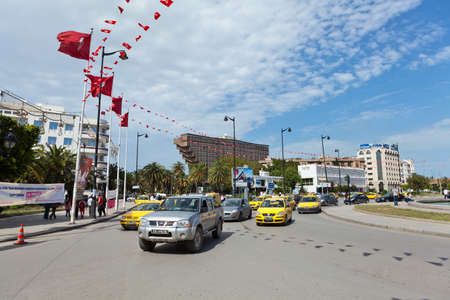 TUNIS, TUNISIA - CIRCA MAY, 2012: Central part of Tunis capital is Habib Bourguiba avenue with many cars on road and big modern buildings, on circa May, 2012 in Tunis, Tunisia.のeditorial素材