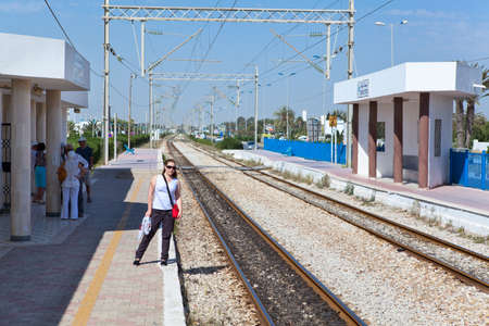 MONASTIR, TUNISIA - CIRCA MAY, 2012: Tourists stand in railway Habib Bourguiba Airport station and waiting intercity train arrival, on circa May, 2012 in Monastir, Tunisia.のeditorial素材