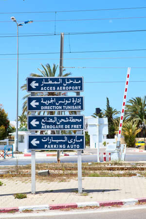 MONASTIR, TUNISIA - CIRCA MAY, 2012: Road sign on the street in front of the airport in Monastir, Tunisia. Direction to aeroport parking and access, on circa May, 2012 in Monastir, Tunisia.のeditorial素材