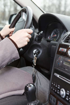 Women hands on steering wheel in land vehicle