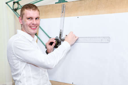 Handsome engineering worker in the workplace near panel board