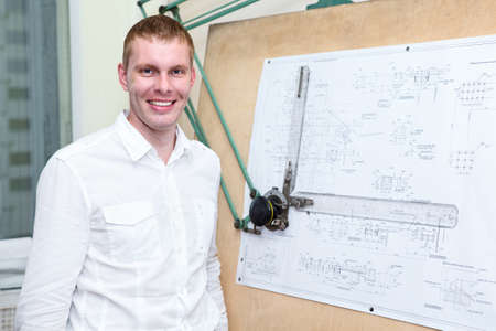 Handsome designer in the workplace near drawing board