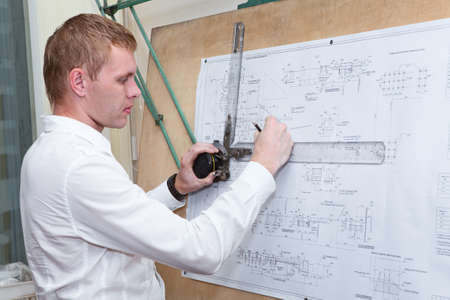 Engineer making a blueprint project with old-fashioned drawing boardの写真素材