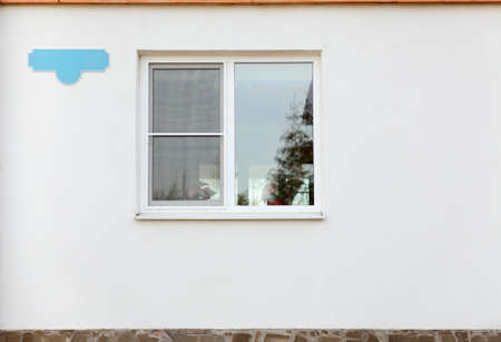 White plastic window in wall with clear address plateの写真素材