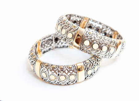 Two white gold braceletes on white background