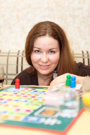 Caucasian woman playing board games in domestic roomの写真素材