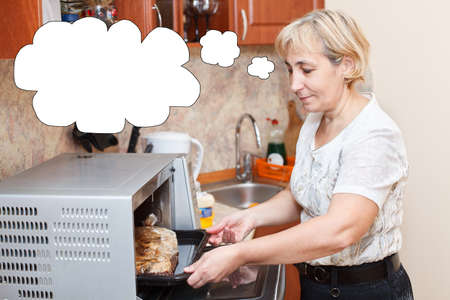 Senior woman cooking in domestic kitchenの写真素材