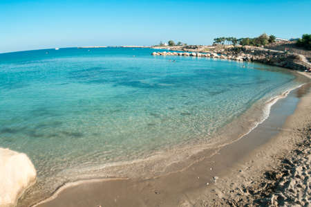 Empty waterfront with sandy beach in Cyprus, Mediterranean seaの写真素材