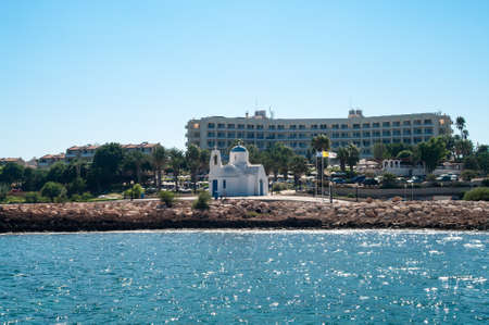 PROTARAS, CYPRUS - CIRCA SEPTEMBER, 2010: Golden Coasts Beach Hotel building with small church for wedding on Mediterranean sea coast in Protaras, Cyprusのeditorial素材