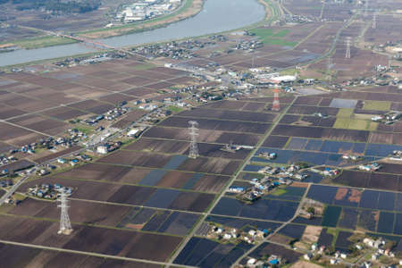 Japanese countryside with rice fields, power electric lines and small villages, Japanの写真素材