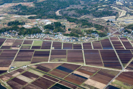 Rice meadows and fields near small Japanese village  Aerial view from aircraft  Japanの写真素材