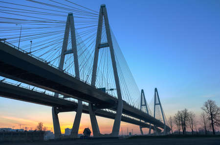 Big suspended bridge during sunrise on blue skyの写真素材