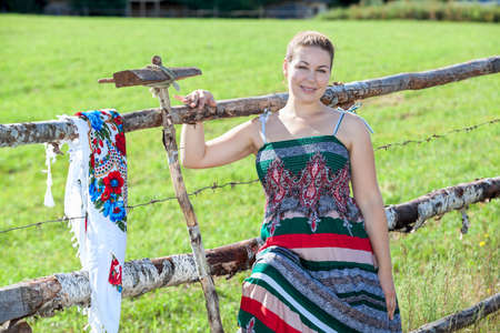 Pretty young village woman resting after work on fieldの写真素材