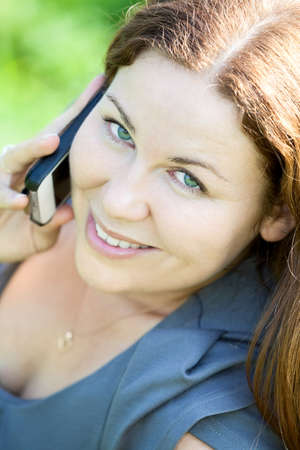 Beautiful Caucasian young woman close-up portrait speaking on phoneの写真素材