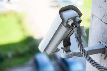 Video surveillance camera on a wall of the building, close up viewの写真素材