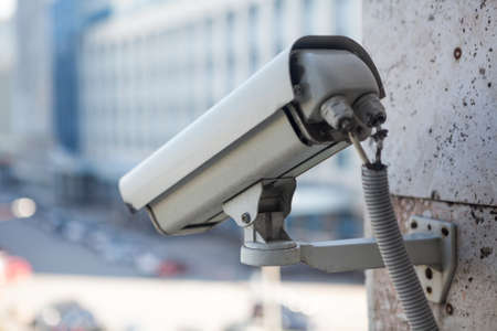 Video surveillance camera on a wall of the buildingの写真素材