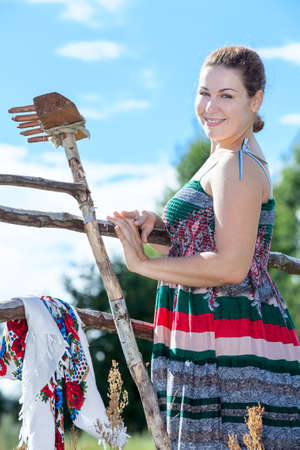 Pretty woman a peasant in village resting after manual workの写真素材