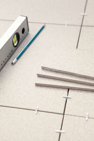 Works on laying of ceramic tiles with levelの写真素材