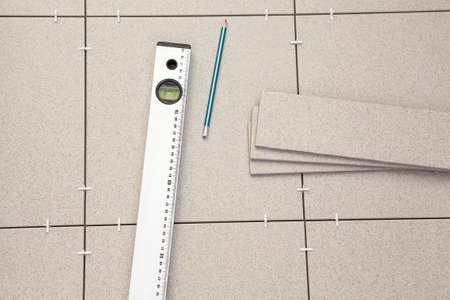 Level with pencil on floorの写真素材