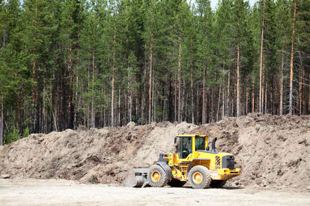 Yellow tractor in sandpitの写真素材