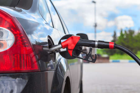 Refueling vehicle with gasoline at city gas station