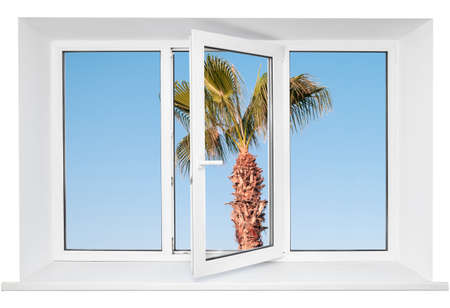 White plastic triple door window with palm tree on blue sky through glass. Isolated on white background. Opened doorの写真素材