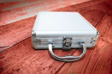 Steel briefcase laying on the red floorの写真素材