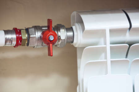 Central heating radiator with closed valve on pipe