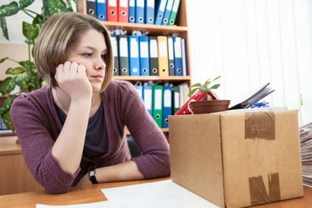 Sad woman in the workplace after dismissalの写真素材